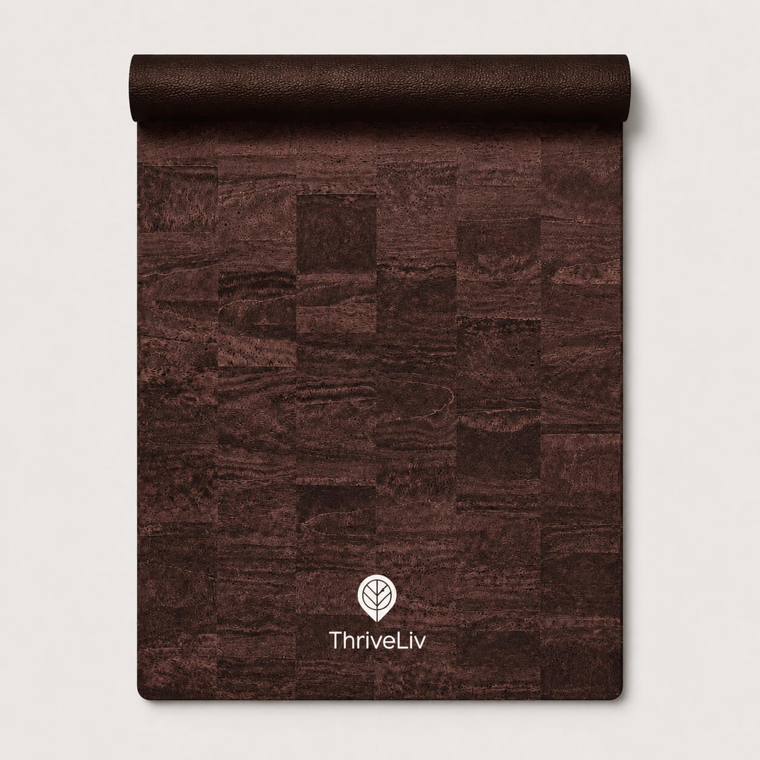A rolled-up dark brown textured mat or rug with a patchwork wood-grain pattern, featuring the white ThriveLiv logo near the bottom, set against a light gray background.