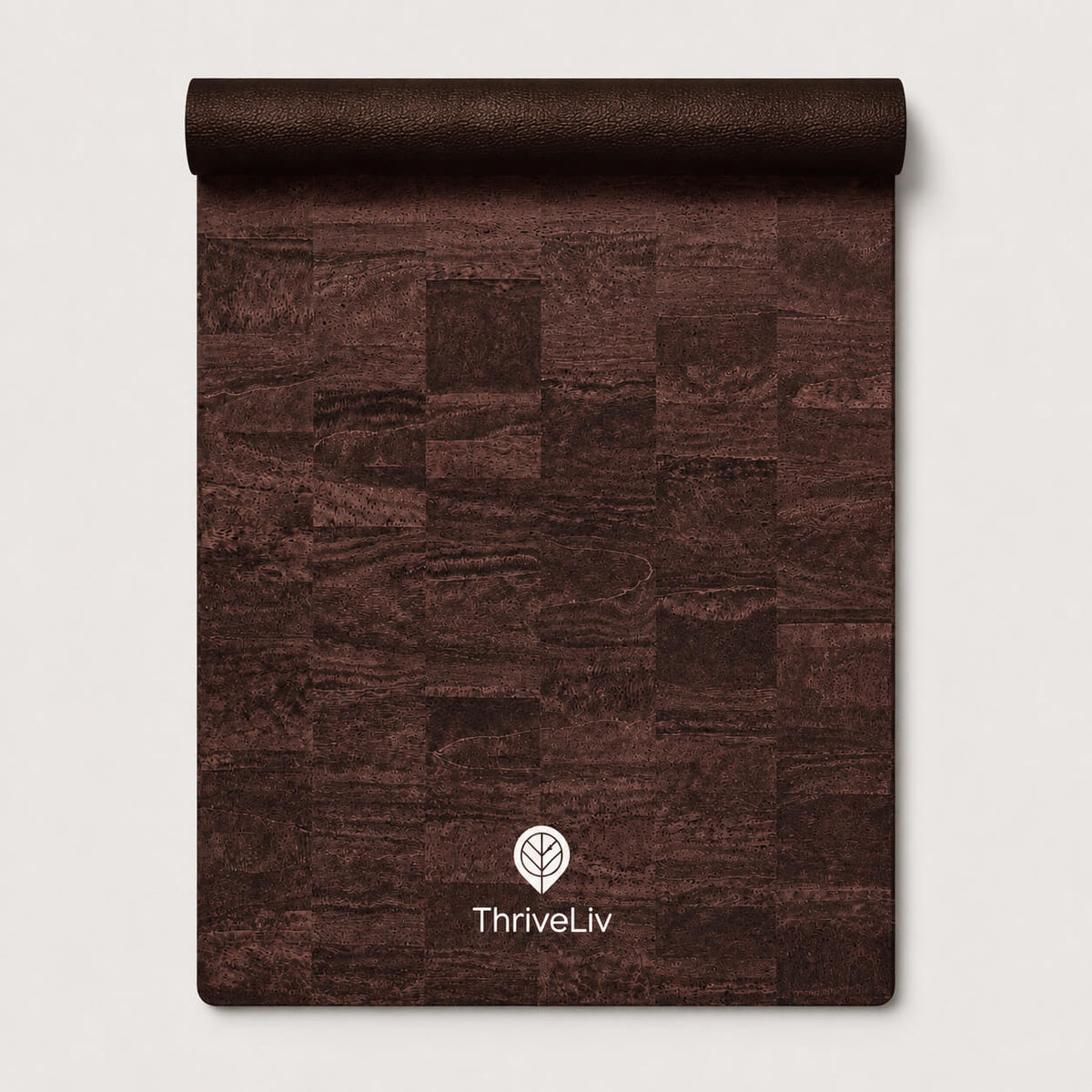 A rolled-up dark brown textured mat or rug with a patchwork wood-grain pattern, featuring the white ThriveLiv logo near the bottom, set against a light gray background.