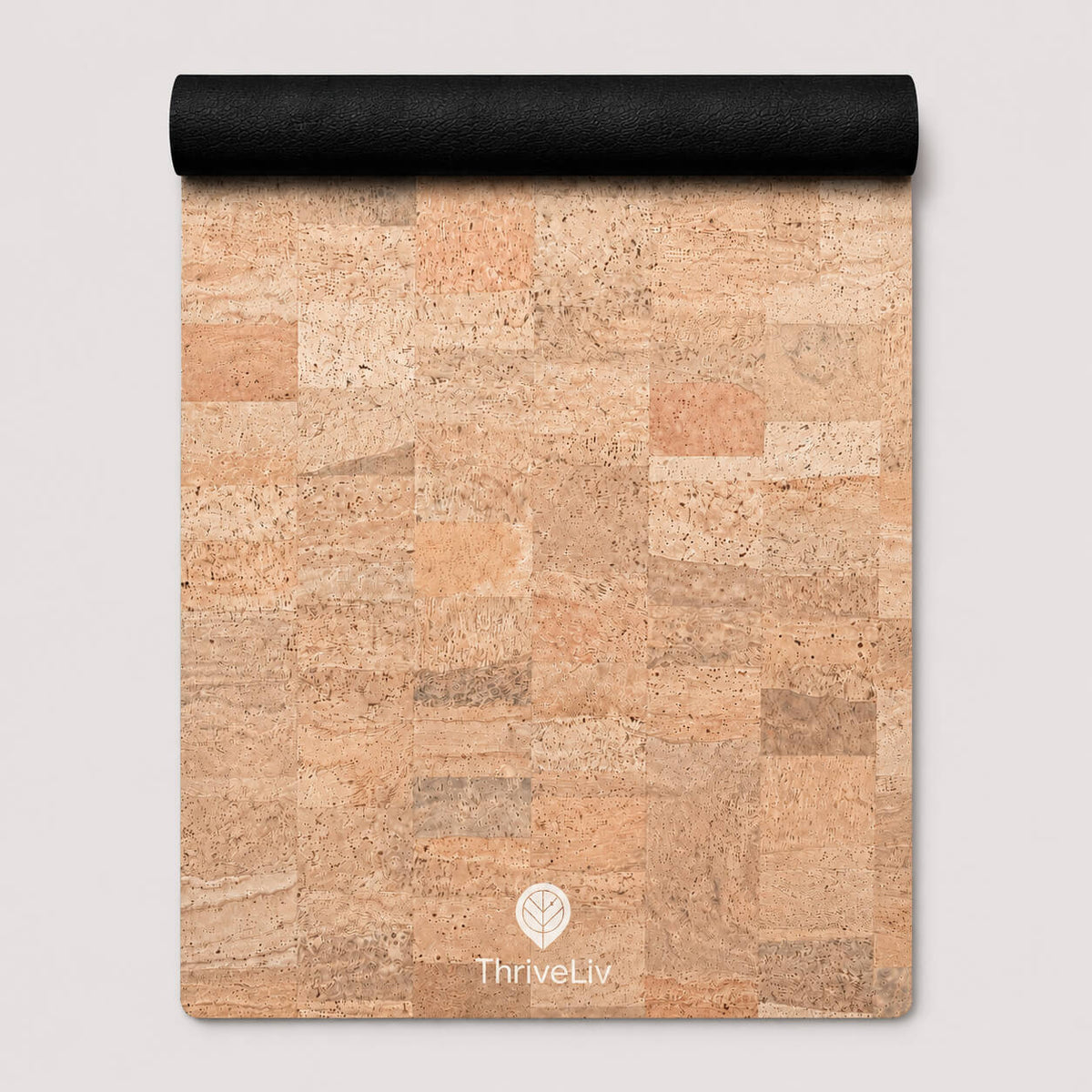 A cork mat with a natural cork patchwork pattern in shades of beige, tan, and brown, featuring a black rolled edge at the top and a white ThriveLiv logo at the bottom.