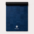 Rolled up blue yoga mat made from cork material