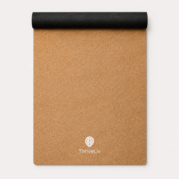 A rolled-up sand coloured yoga mat, showing the black reverse grip, shown on a clean white background. The ThriveLiv logo is printed near the bottom.
