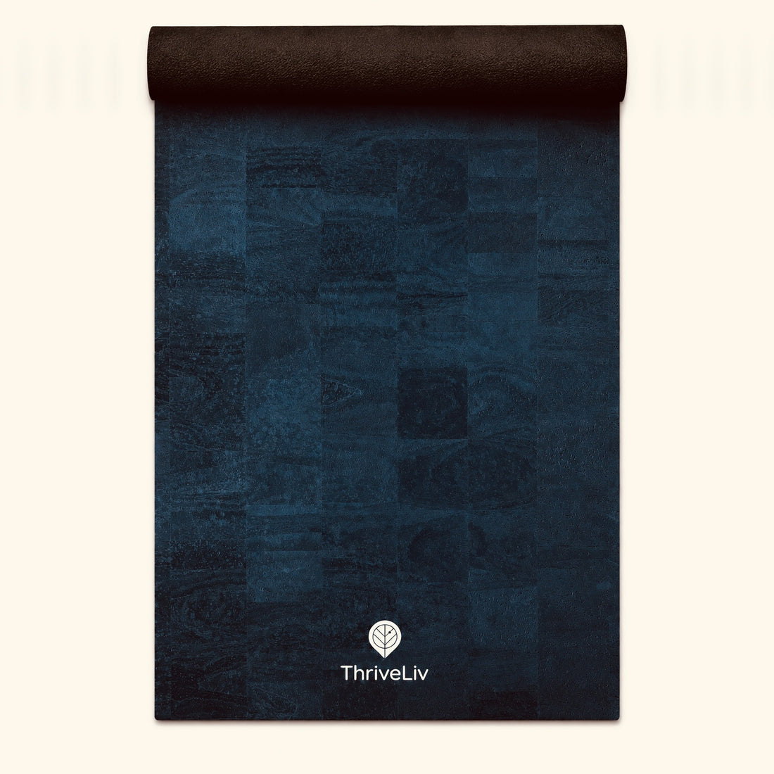 A dark navy blue yoga mat with a textured patchwork design and a rolled top edge, featuring the ThriveLiv logo near the bottom, set against a light cream background.